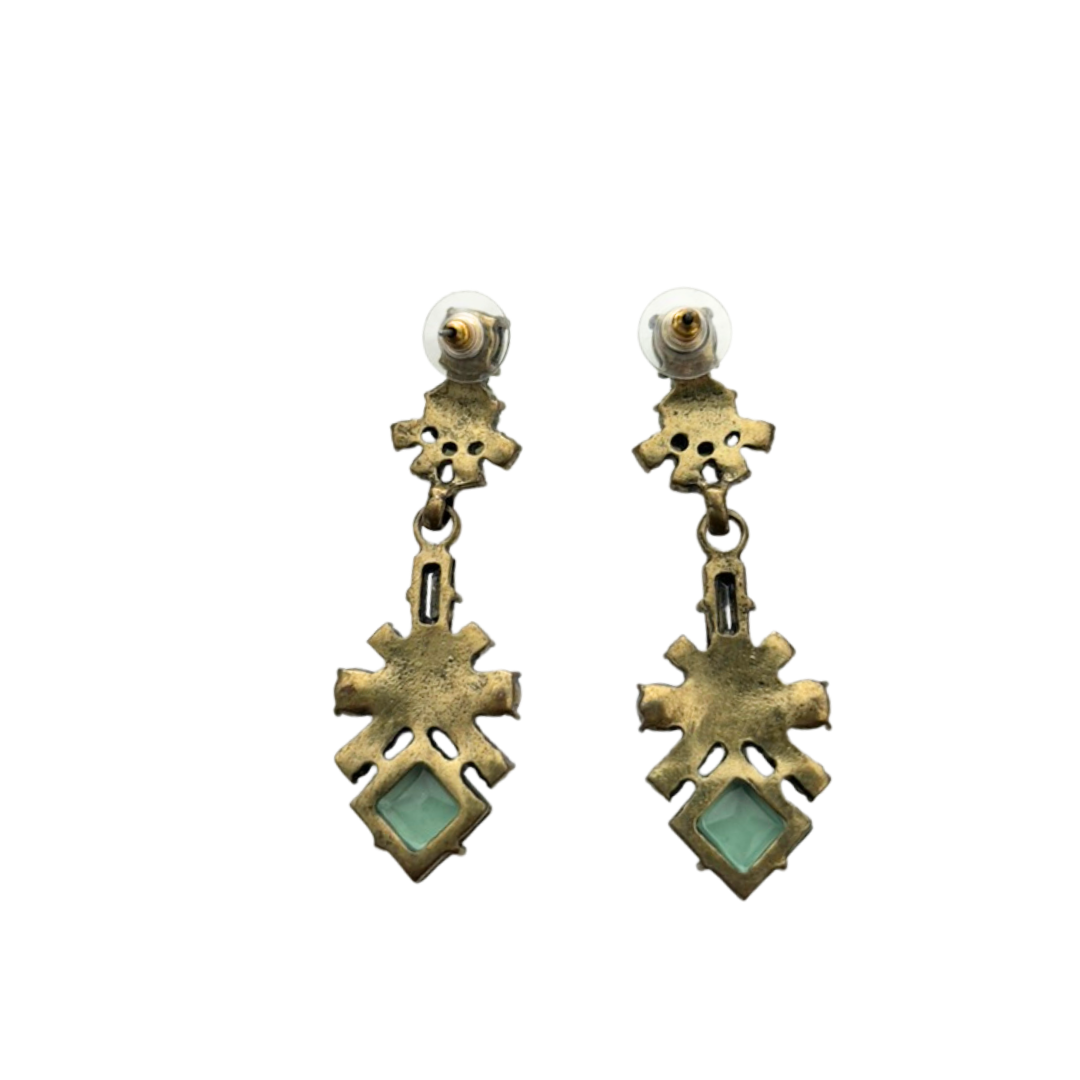 Pair of gold and green earrings on a white background