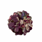 Multicolored fabric brooch on a white background