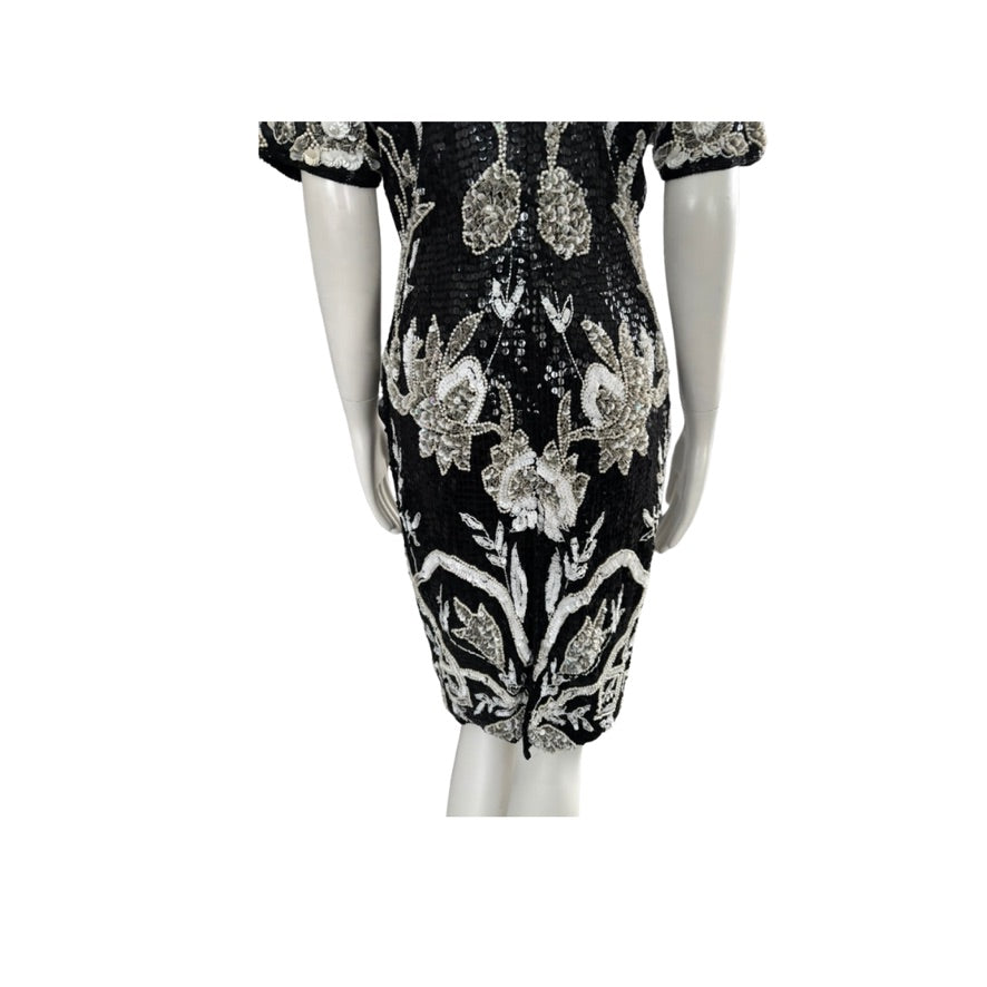 Black dress with floral embroidery on a white background