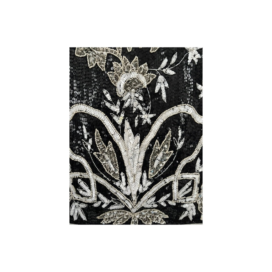 Decorative black fabric with silver floral patterns on a white background