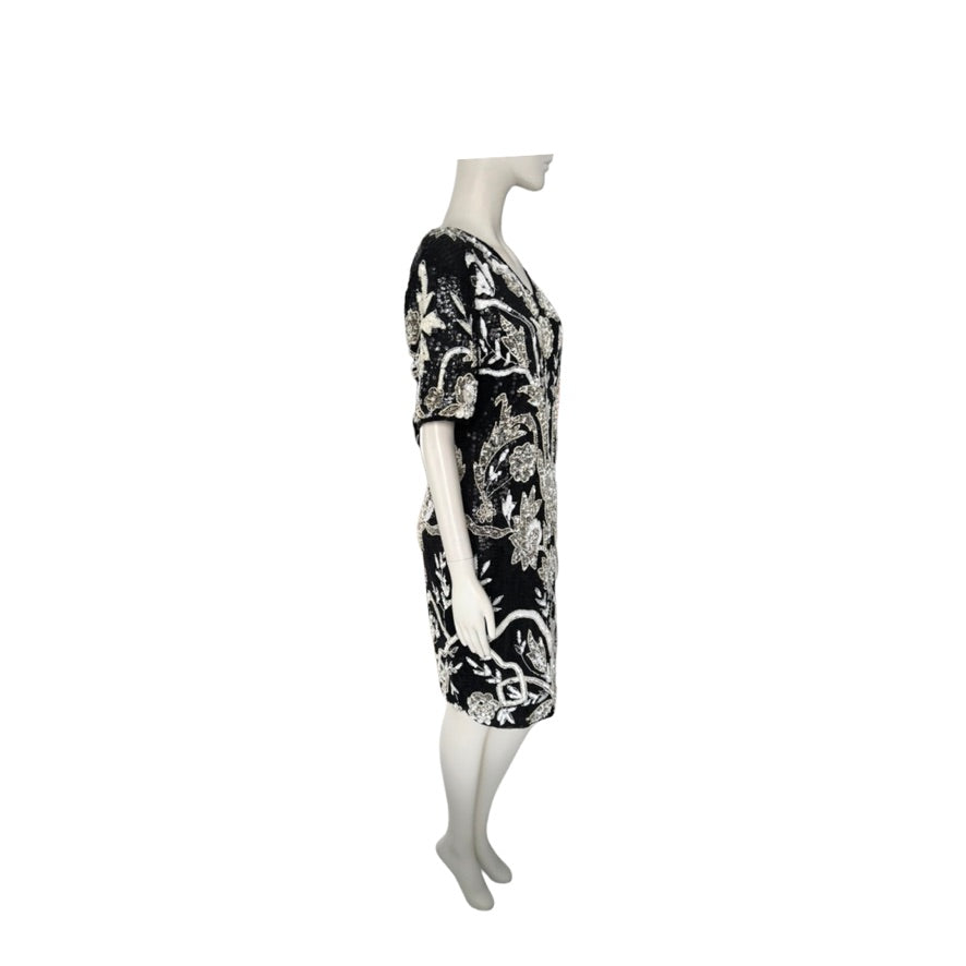 Mannequin wearing a black and white patterned dress on a white background