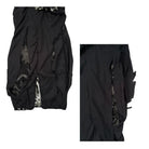 Black garment with intricate detailing on a white background