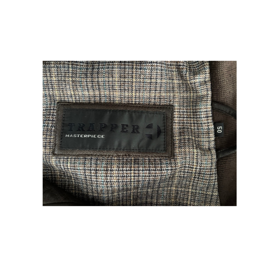 Close-up of a textured fabric with a 'Trapper' label on a white background