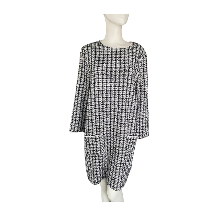 Black and white checkered dress on a mannequin against a white background