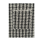 Black and white checkered pattern on a textured surface