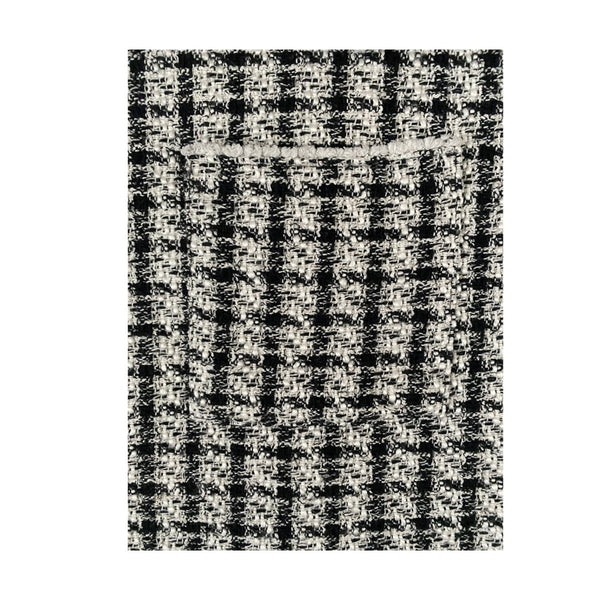 Black and white checkered pattern on a textured surface