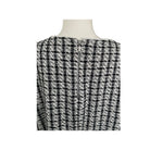 Black and white checkered dress on a mannequin against a white background