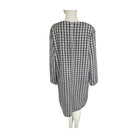 Black and white checkered dress on a mannequin against a white background