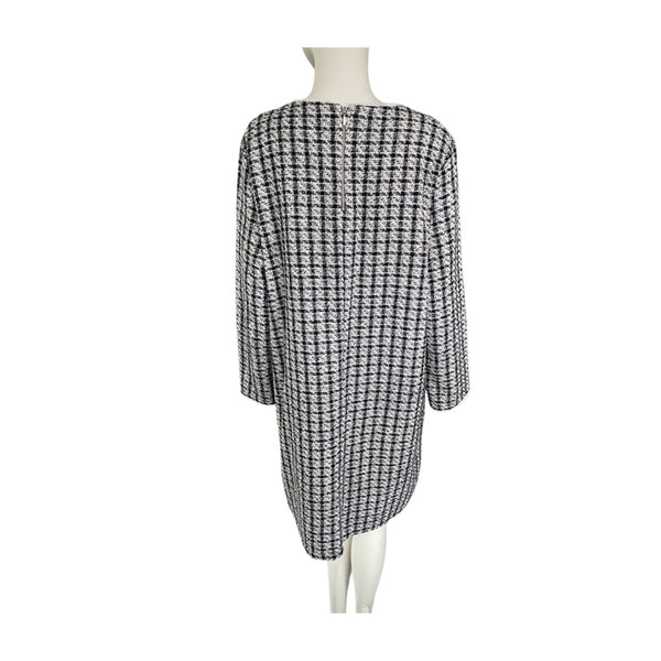 Black and white checkered dress on a mannequin against a white background