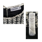 Close-up of a garment with 'GALLERY' label and fabric composition label on a white background