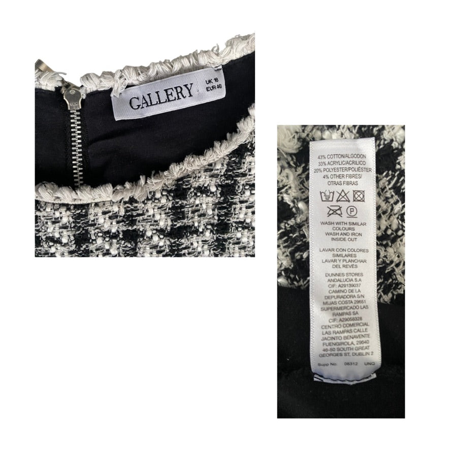 Close-up of a garment with 'GALLERY' label and fabric composition label on a white background
