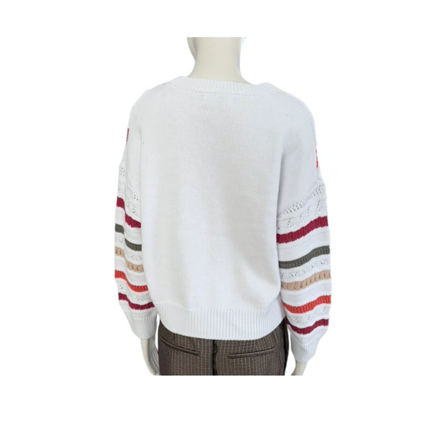 White sweater with colorful striped sleeves on a mannequin against a white background