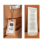 Close-up of clothing tags on a brown fabric background