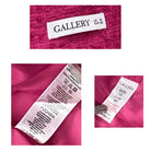 Close-up of clothing labels on a pink fabric background