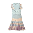 Two-piece outfit with a light blue top and striped skirt on a white background