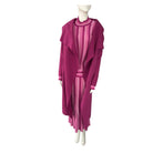 Mannequin wearing a magenta dress with sheer panels on a white background