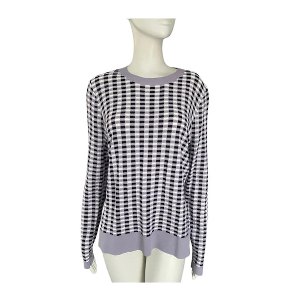 Black and white and lilac checkered sweater on a mannequin against a white background