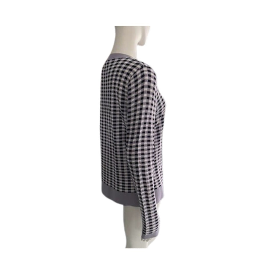 Mannequin wearing a black and white checkered dress on a white background