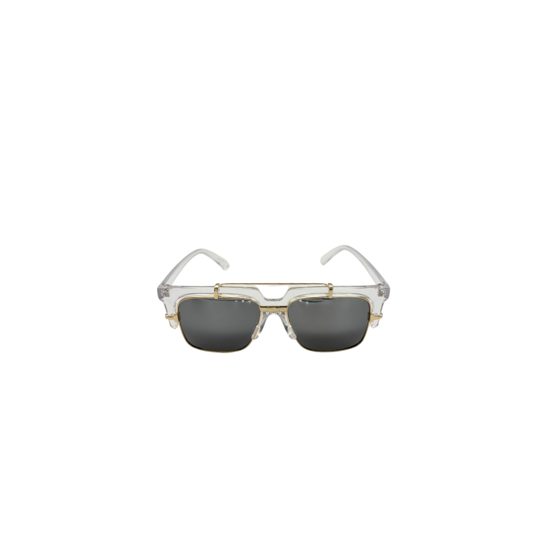 Sunglasses with gold frame and clear temple tips on a white background