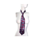 Patterned tie on a mannequin against a white background