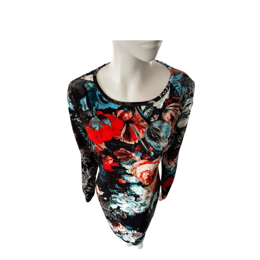 Mannequin wearing a colorful floral dress on a white background