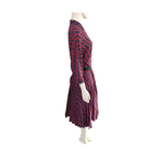 Mannequin wearing a red and blue patterned dress on a white background