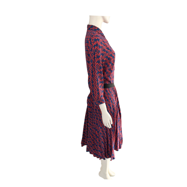 Mannequin wearing a red and blue patterned dress on a white background