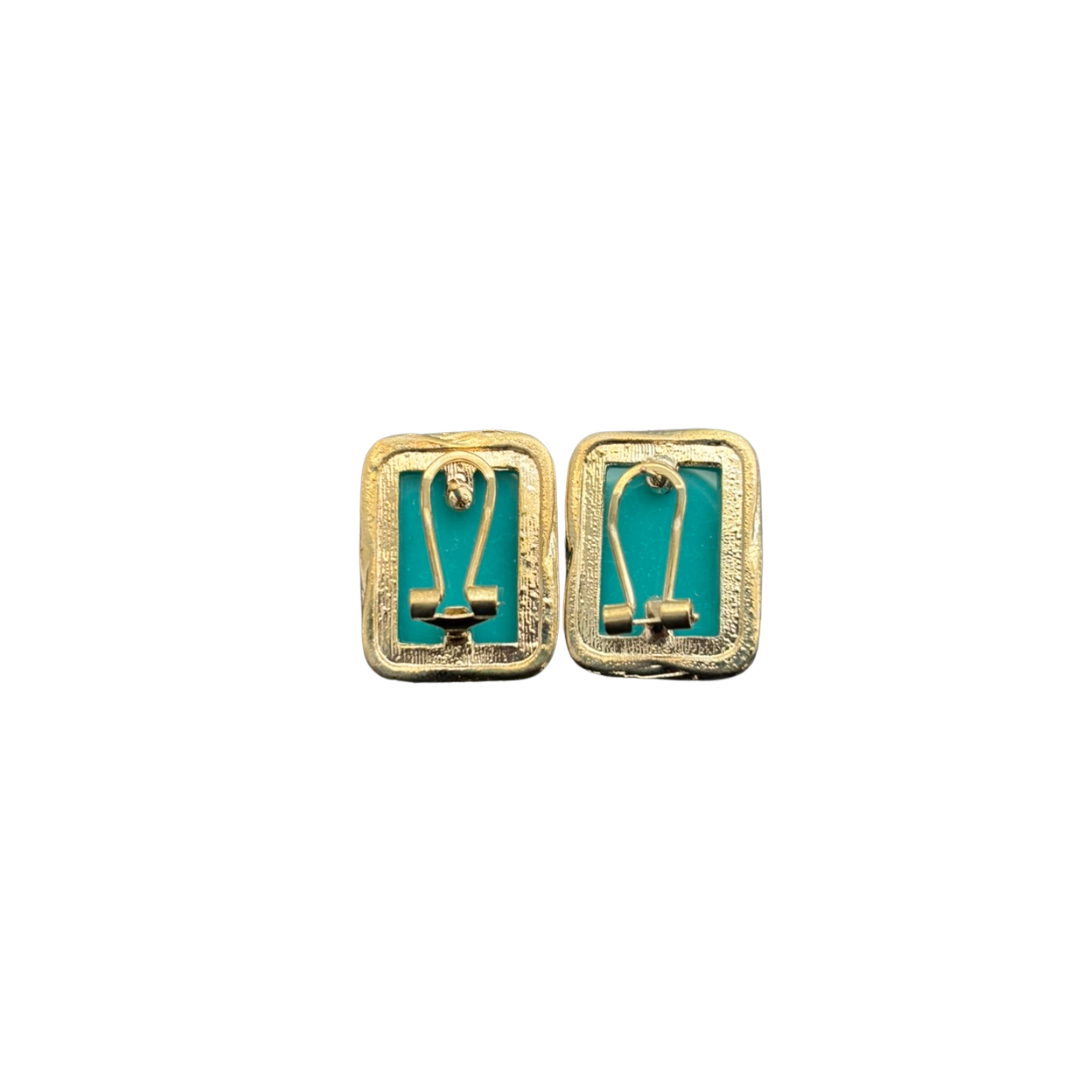 Pair of gold earrings with turquoise stones on a white background