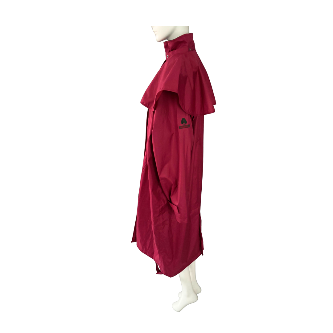 Red raincoat on a mannequin against a white background