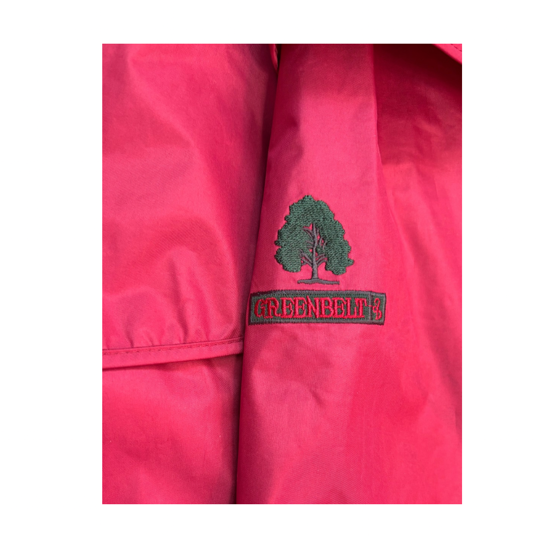 Close-up of a red jacket with a Greenbelt logo on a white background
