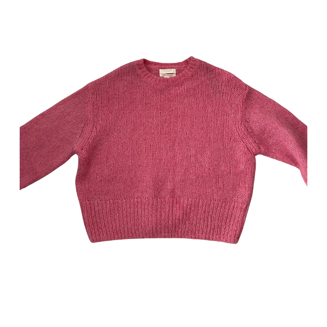 Pink knitted sweater on a white background