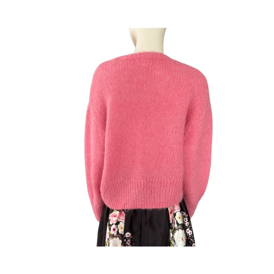 Pink sweater on a mannequin with a white background