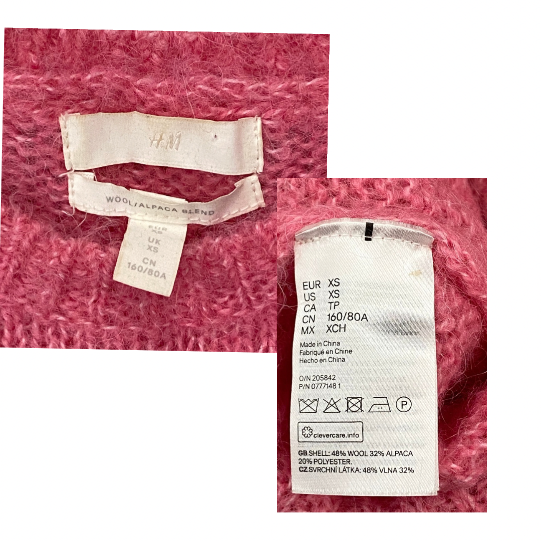 Close-up of clothing labels on a pink fabric background