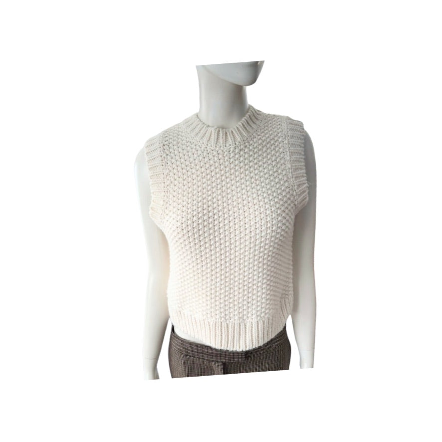 White knitted sleeveless sweater on a mannequin against a white background