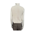 Mannequin wearing a cream knitted vest and brown plaid pants on a white background