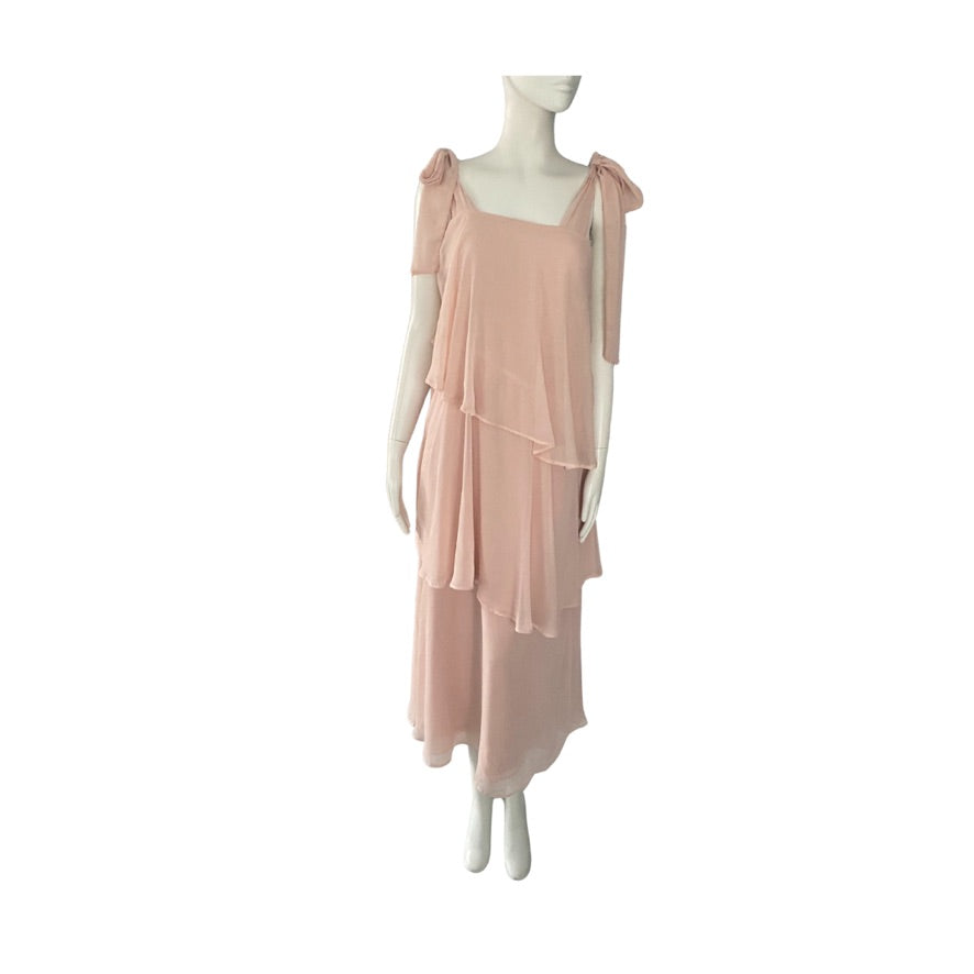 Mannequin wearing a light pink dress on a white background
