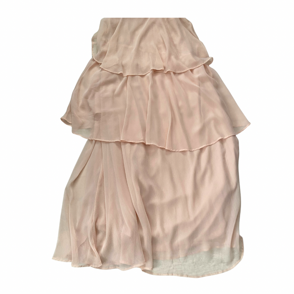 Pink ruffled dress close-up on a white background