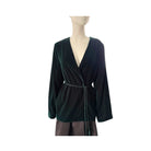 Green velvet jacket on a mannequin against a white background