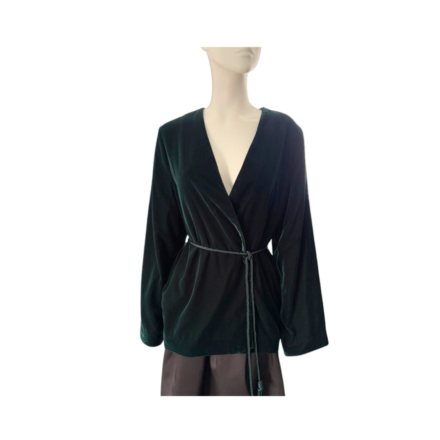 Green velvet jacket on a mannequin against a white background