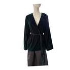 Mannequin wearing a dark green velvet wrap dress with a white background