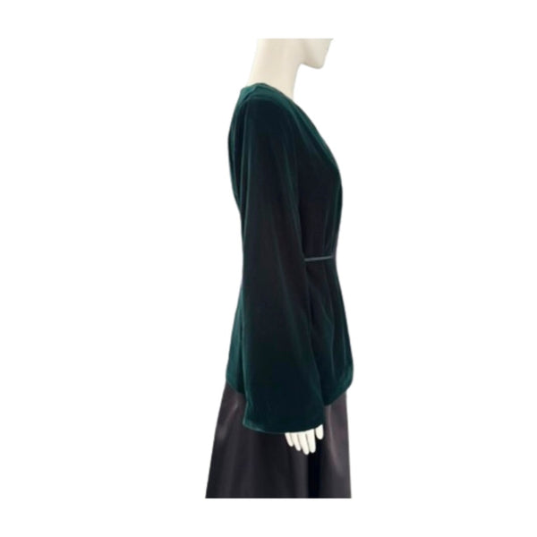 Green dress on a mannequin against a white background