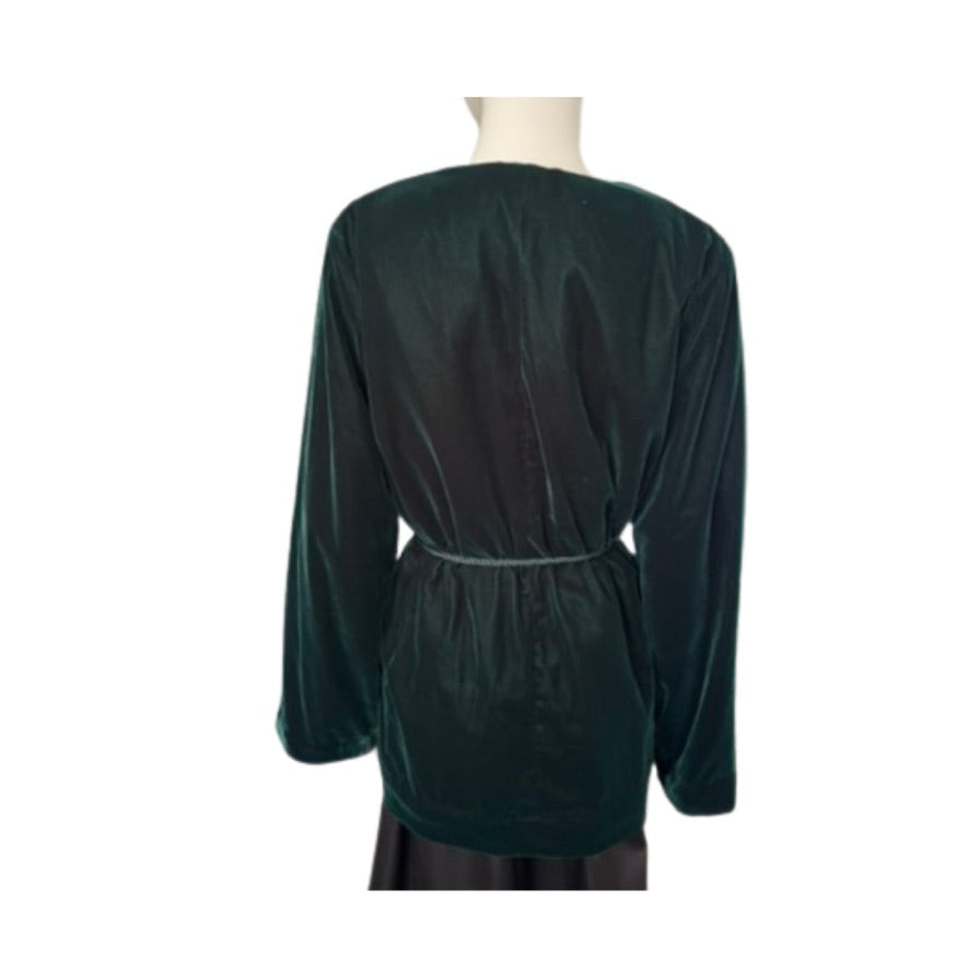 Green velvet dress on a mannequin with a white background