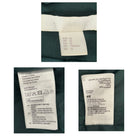 Close-up of H&M clothing labels on a green fabric background