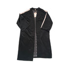 Black dress with intricate white embroidery on a white background