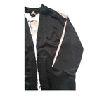 Black jacket with a visible brand label on a white background