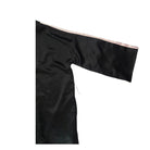 Black satin fabric with a pink border on a white background
