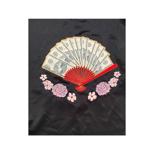 Embroidered fan and floral design on a black fabric background