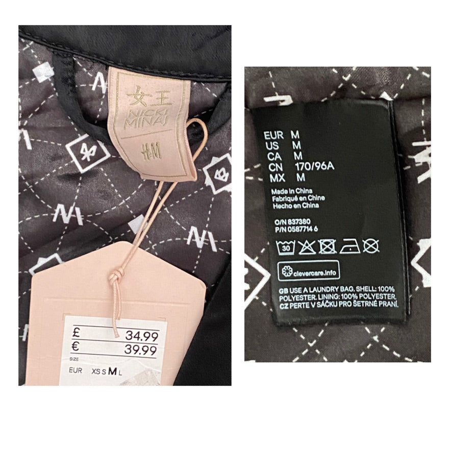 Close-up of a clothing label with brand name and size information on a black garment with white patterns.
