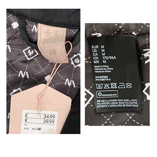 Close-up of a clothing label with brand name and size information on a black garment with white patterns.