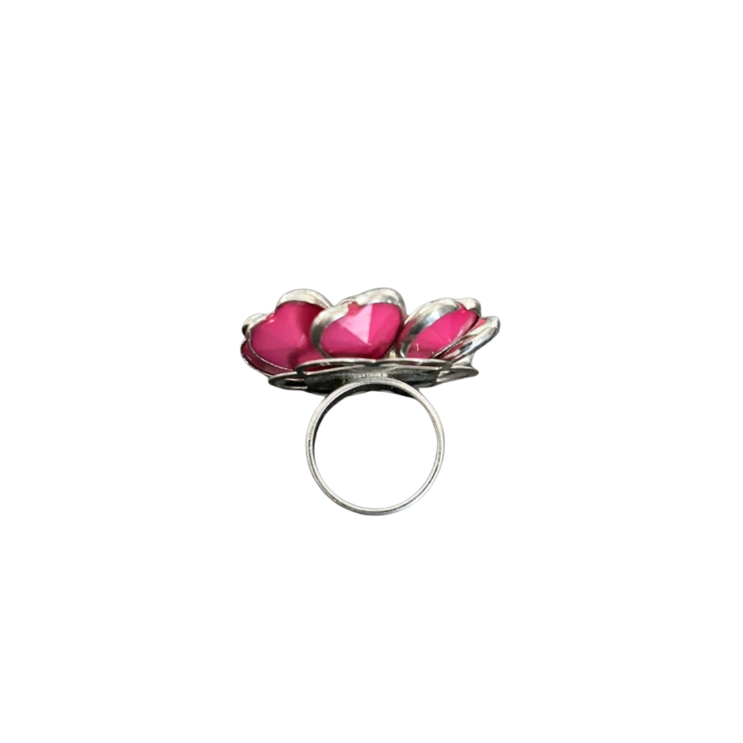 Silver ring with pink heart-shaped stones on a white background